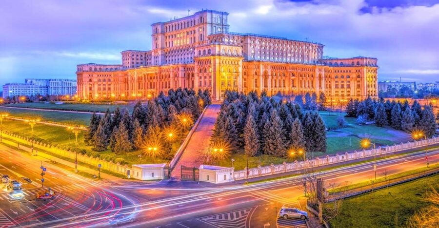 The Palace of Parliament lit up above Bucharest after dark