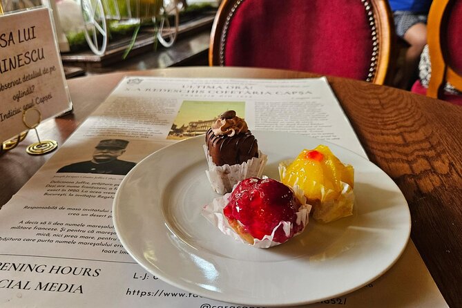 Sweet Delights History and Desserts Walking Tour in Bucharest - Revolution Square with a Romanian chocolate bar